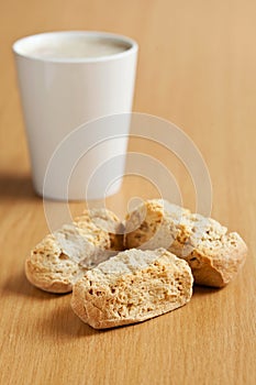 Three rusks with a mug of coffee