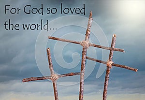 Three rustic, homemade crosses in front of a stormy sky representing the Good Friday crucifixion of Jesus Christ prior to the