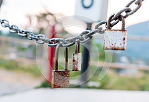 Three rusty padlocks with chain, Selective focus.