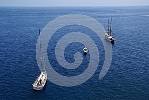 three sail boats in blue sea