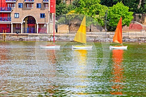 Three sailing dinghies float on Shadwell Basin in London photo