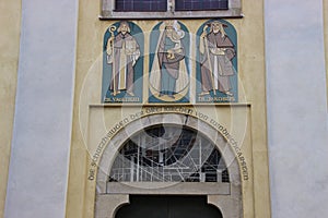 Three saints on the facade of Saint John Parish Church built in 1408 in the historic market town Windischgarsten.