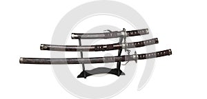 Three samurai swords on a stand on a white background