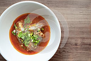 Three sardines in tomato sauce sprinkle on top with coriander and spring onion