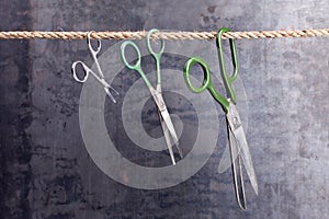 Three scissors hanging on a rope