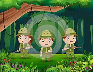 Three Scout boy in uniform exploring the forest