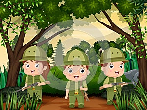 Three Scout boy in uniform exploring the forest