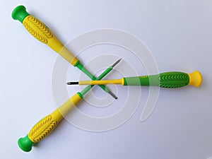 Three Screwdrivers that cross on a white background