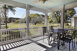 Three season screen porch with view out onto golf course and park photo