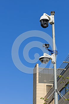 Three security cameras on a pole.