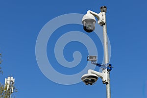 Three security cameras on a pole.
