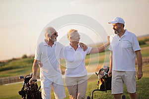 Three senior golfers talking
