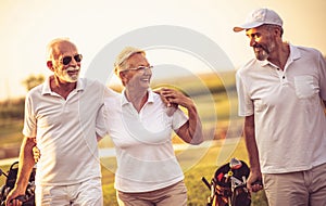 Three senior golfers talking