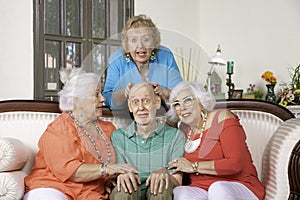 Three Senior Women Lavishing Affection on a Surprised Single Man