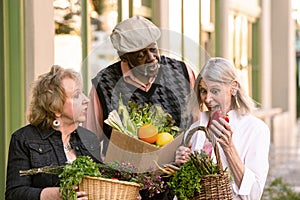 Three Seniors Comparing Purchases from Farmers Market