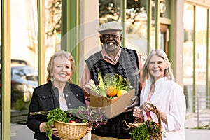Three Seniors Returning from Farmers Market with Groceries