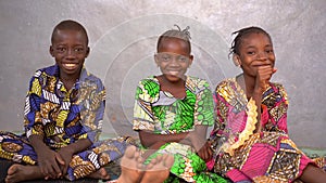 Three Serious Little African Children Bursting Out Laughing