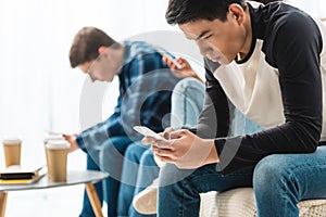 three serious teenagers sitting