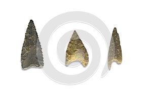 Three serrated stone arrowheads