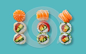 Three sets of succulent, bright and vibrant salmon sushi roll, with sushi rice and rocket salad on a light blue background