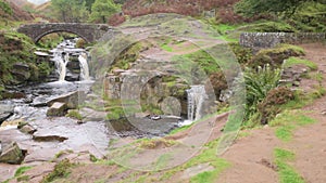 Three Shire Heads. An autumnal waterfall and stone packhorse bridge at Three Shires Head in the Peak District
