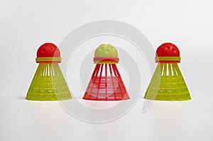 three shuttlecocks for playing crossminton on a white background.