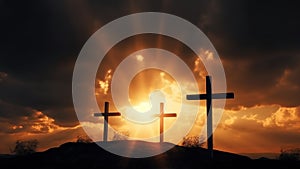 Three silhouetted religious crosses on hillside with orange sunset background, crucifixion concept.