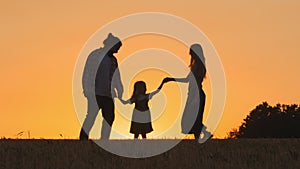 Three silhouettes happy carefree cheerful family parents mother father daughter woman and man with child girl kid in