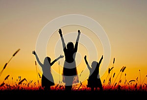 Family silhouettes at sunset mom daughters photo