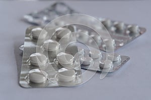 Three silver pill blisters on white background