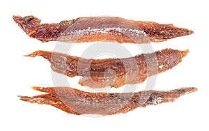 Three single oiled anchovy fillets isolated