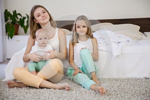 Three sisters in the morning in a bedroom of parents