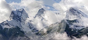 Three Sisters peeking through the clouds