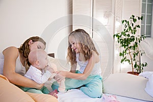 Three sisters play children in the morning in the bedroom