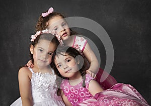 Three sisters sitting close romantic style portrait