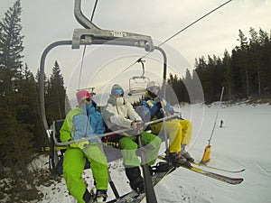 Skiers on a chair lift