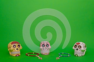 Three skulls of different colors of the Dia de los muertos