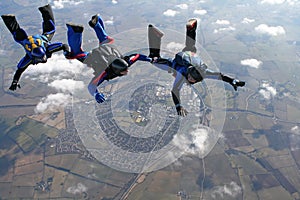 Three skydivers in a line behind each other photo