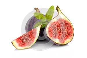 Three sliced figs with mint isolated on white background