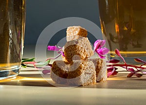 Three slices of cane sugar with a flower