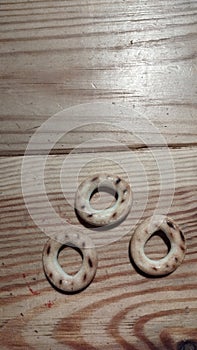 three small bagels on a wooden table