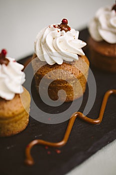 Three small cakes on a green background.