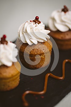 Three small cakes on a green background.