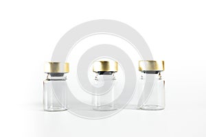 Three small empty glass vials on a white background. Medicine bottles. Copy space