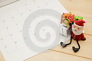 Three small gift box and satan claus put on wooden background