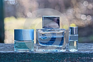 three small glass bottles with colored perfume