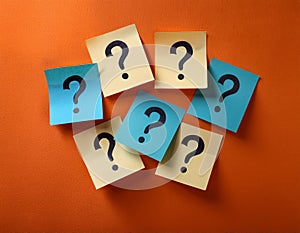 Paper notes with question marks on orange background, flat lay. Space for text