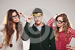 Three smart student friends looking with eyeglasses