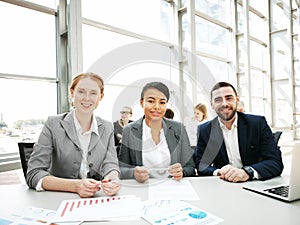 Three smiling business people