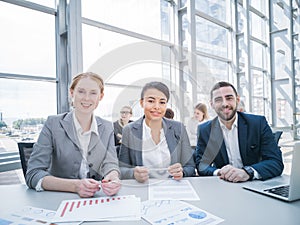 Three smiling business people